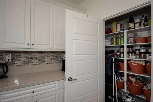 a kitchen with a refrigerator and cabinets