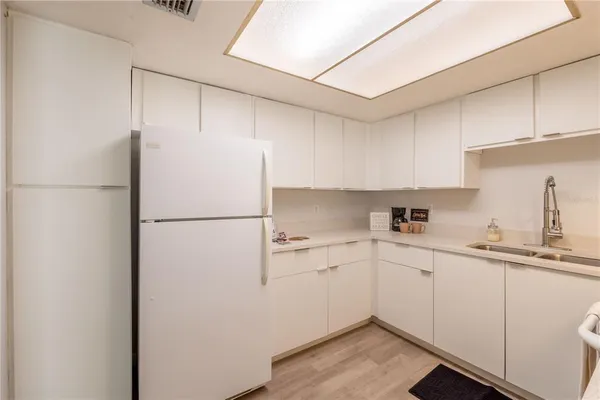 a kitchen with stainless steel appliances a stove a sink and a refrigerator