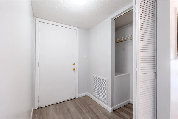 a view of hallway with wooden floor