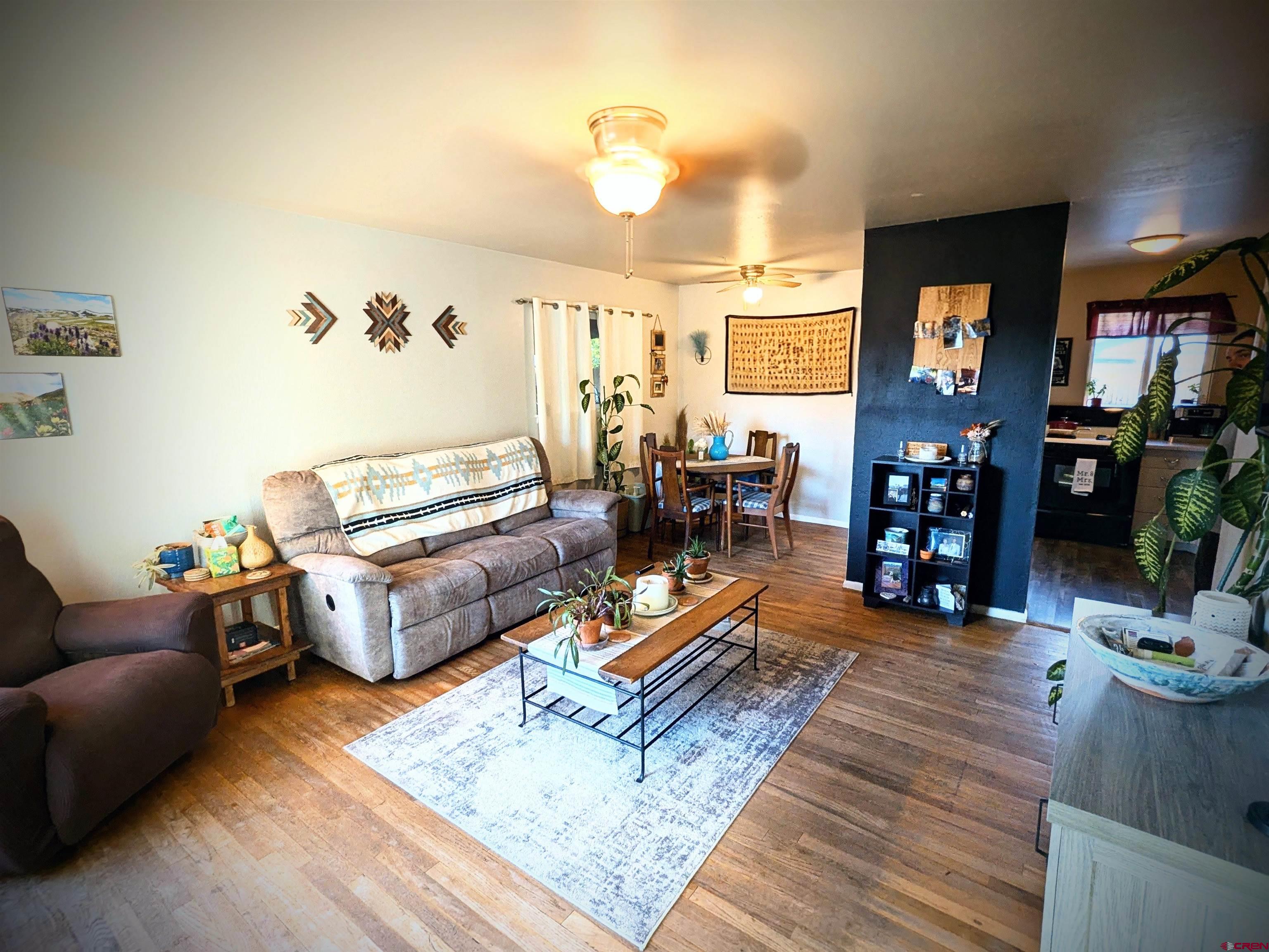 714 East 3rd Street Cortez, CO 81321 - Photo 3 of 14 a living room with furniture and wooden floor