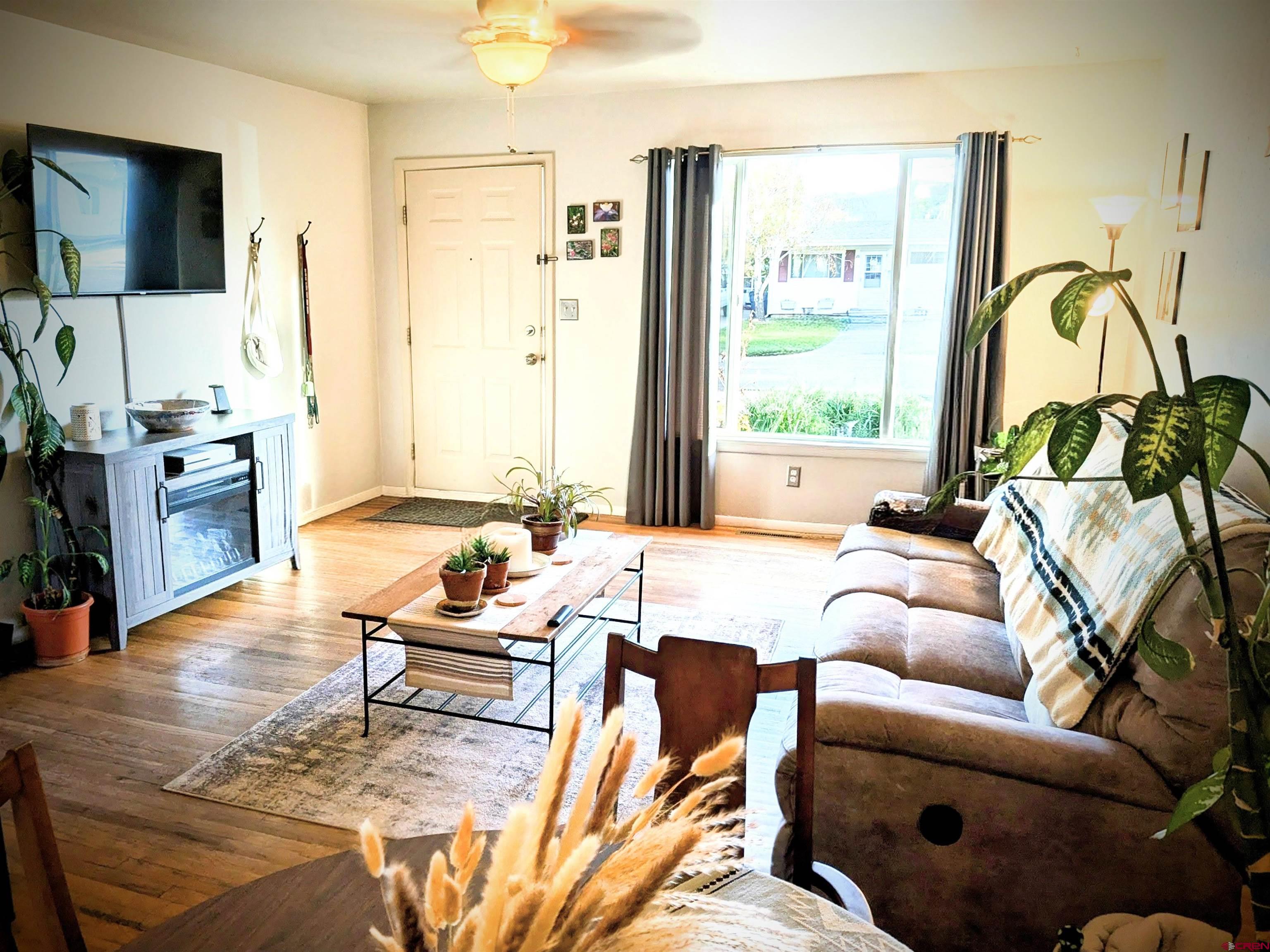 714 East 3rd Street Cortez, CO 81321 - Photo 4 of 14 a living room with furniture and a flat screen tv