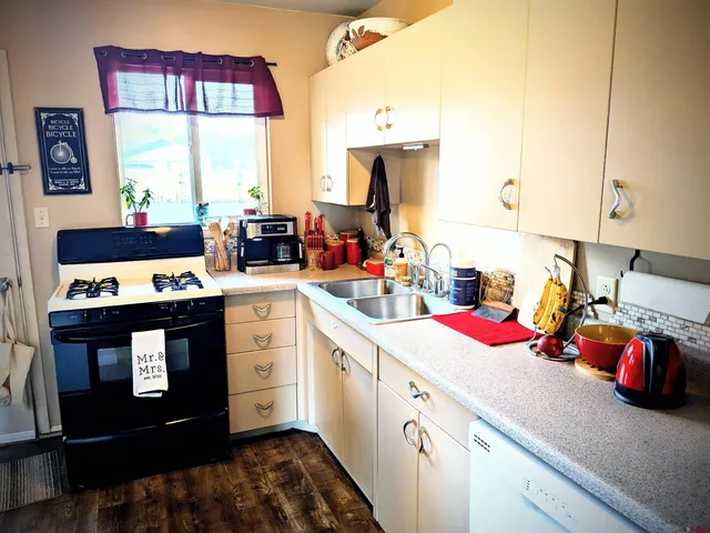 a view of a kitchen with sink and cabinets