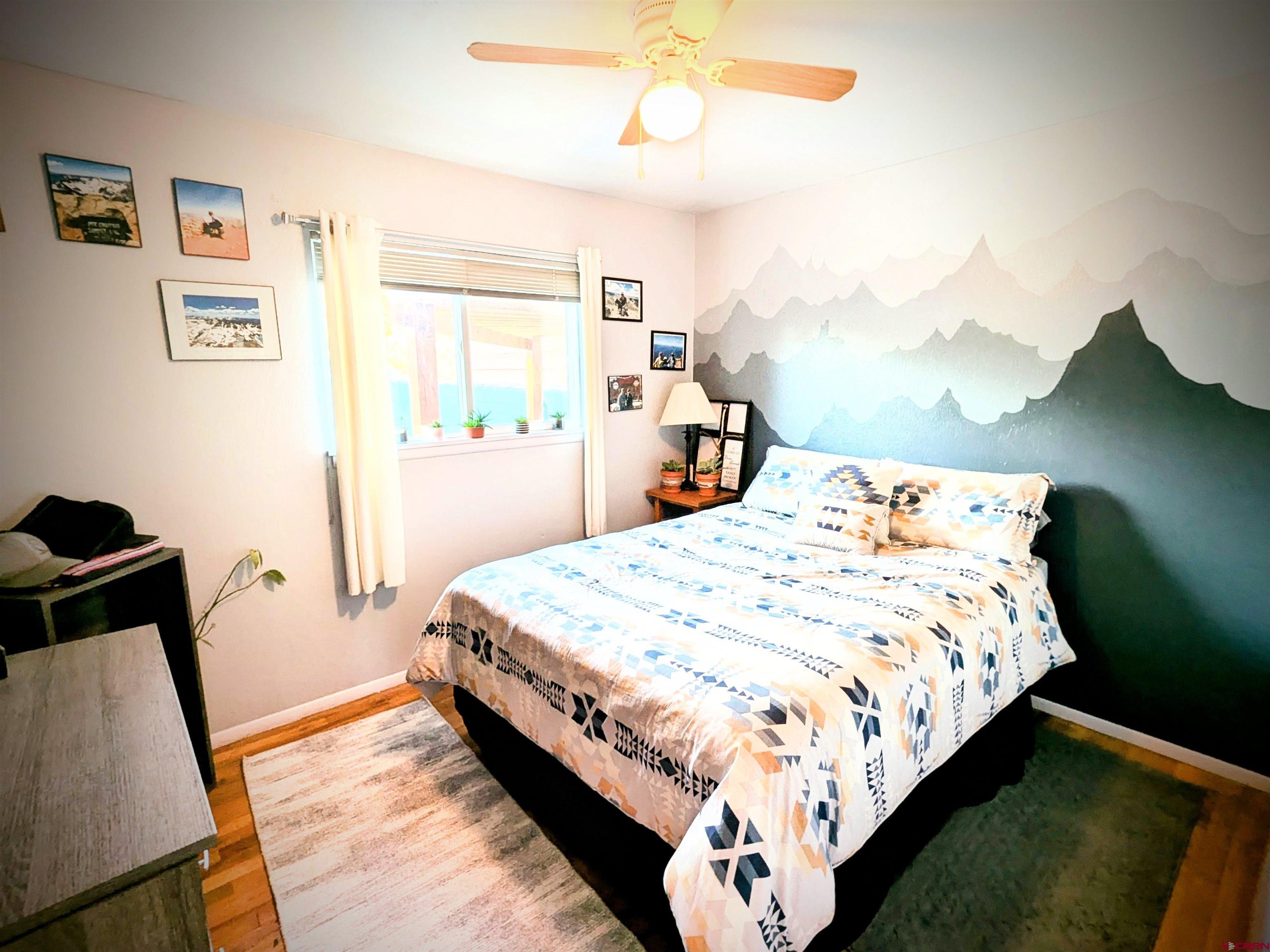 714 East 3rd Street Cortez, CO 81321 - Photo 10 of 14 a bed sitting in a bedroom next to a window