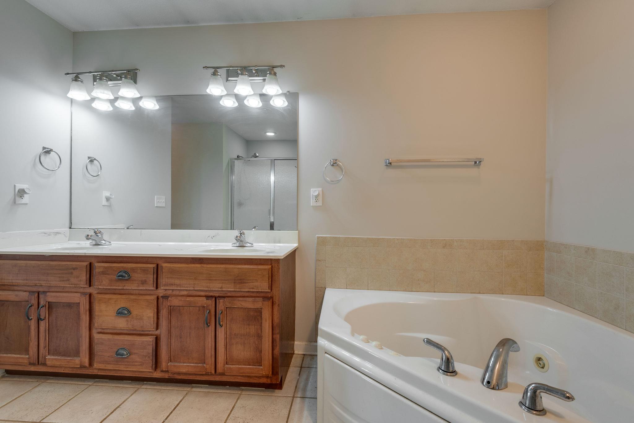 3753 Trough Springs Road Adams, TN 37010 - Photo 18 of 28 a bathroom with a tub sink and mirror