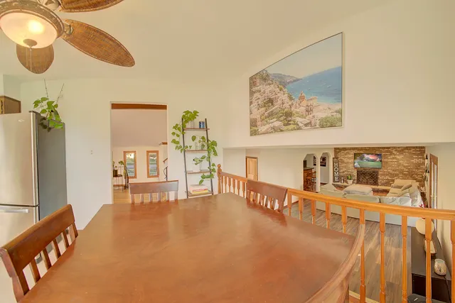a dining room with furniture and a flat screen tv