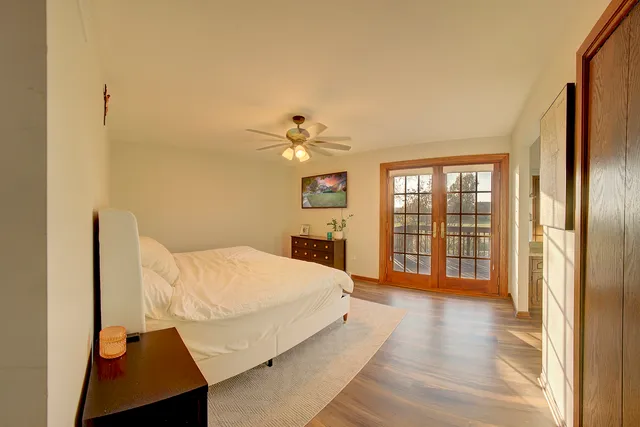 a living room with a bed furniture and a large window