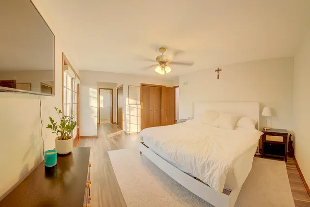 a bedroom with a bed and a chandelier
