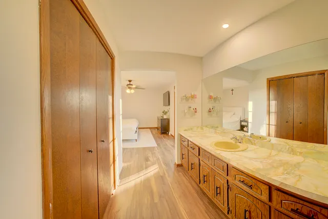 a spacious bathroom with a tub sink shower and a mirror