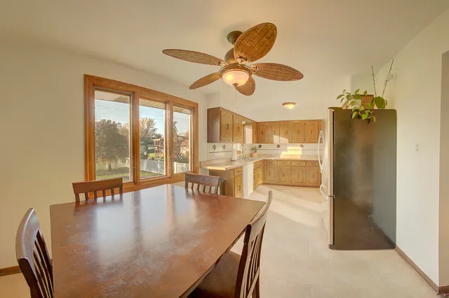 a view of a dining room and livingroom with furniture wooden floor a chandelier