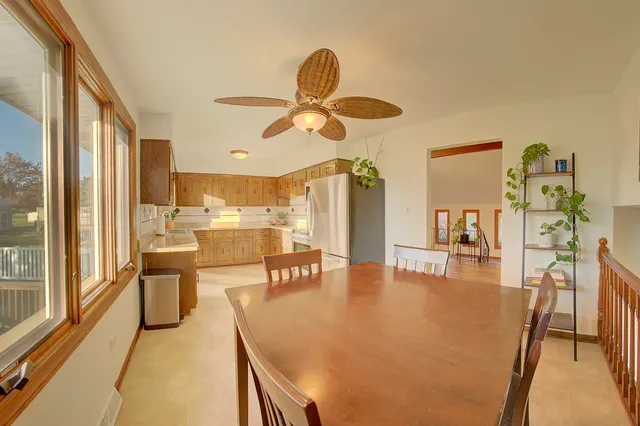 a dining room with furniture and a large window