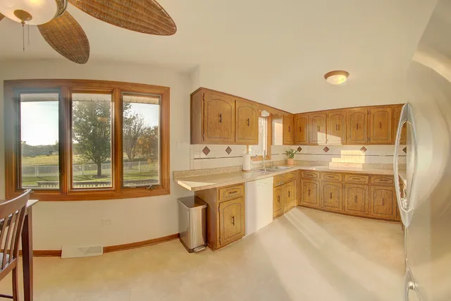 a large white kitchen with a large window