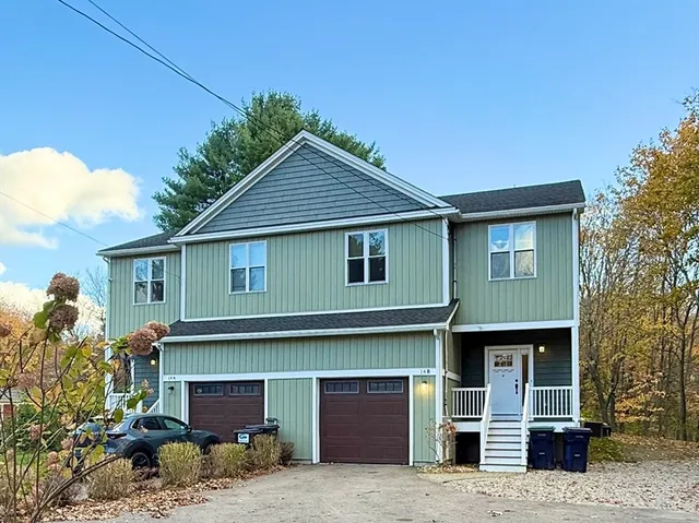 a front view of a house with garage