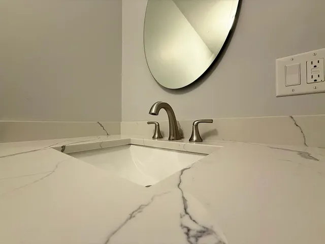 a bathroom with a sink and mirror