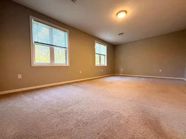 an empty room with a empty space and windows