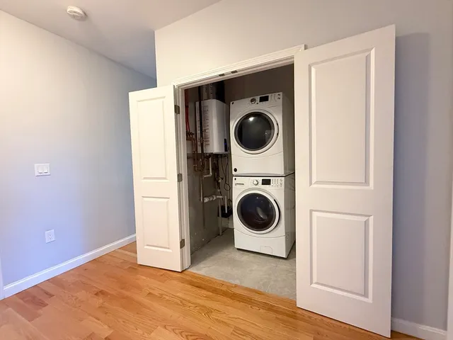 a view of a storage & utility room with a washer dryer