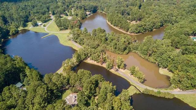 an aerial view of residential house with outdoor space and swimming pool