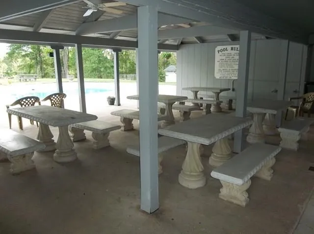 a dining room with furniture and a floor to ceiling window
