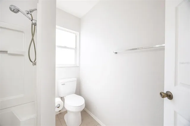 a bathroom with a toilet sink and shower