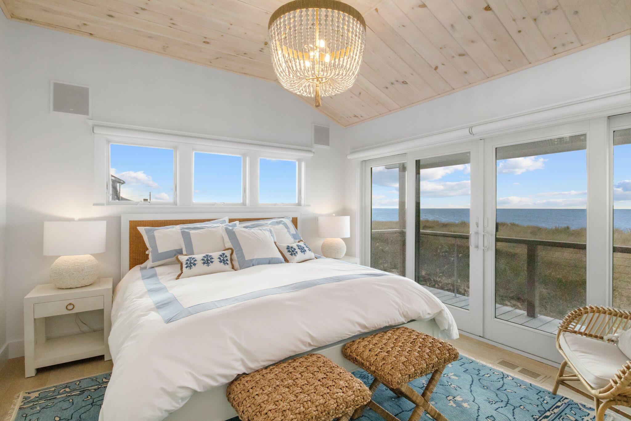 165 Harmes Way Eastham, MA 02642 - Photo 13 of 36 a bedroom with a bed and a chandelier