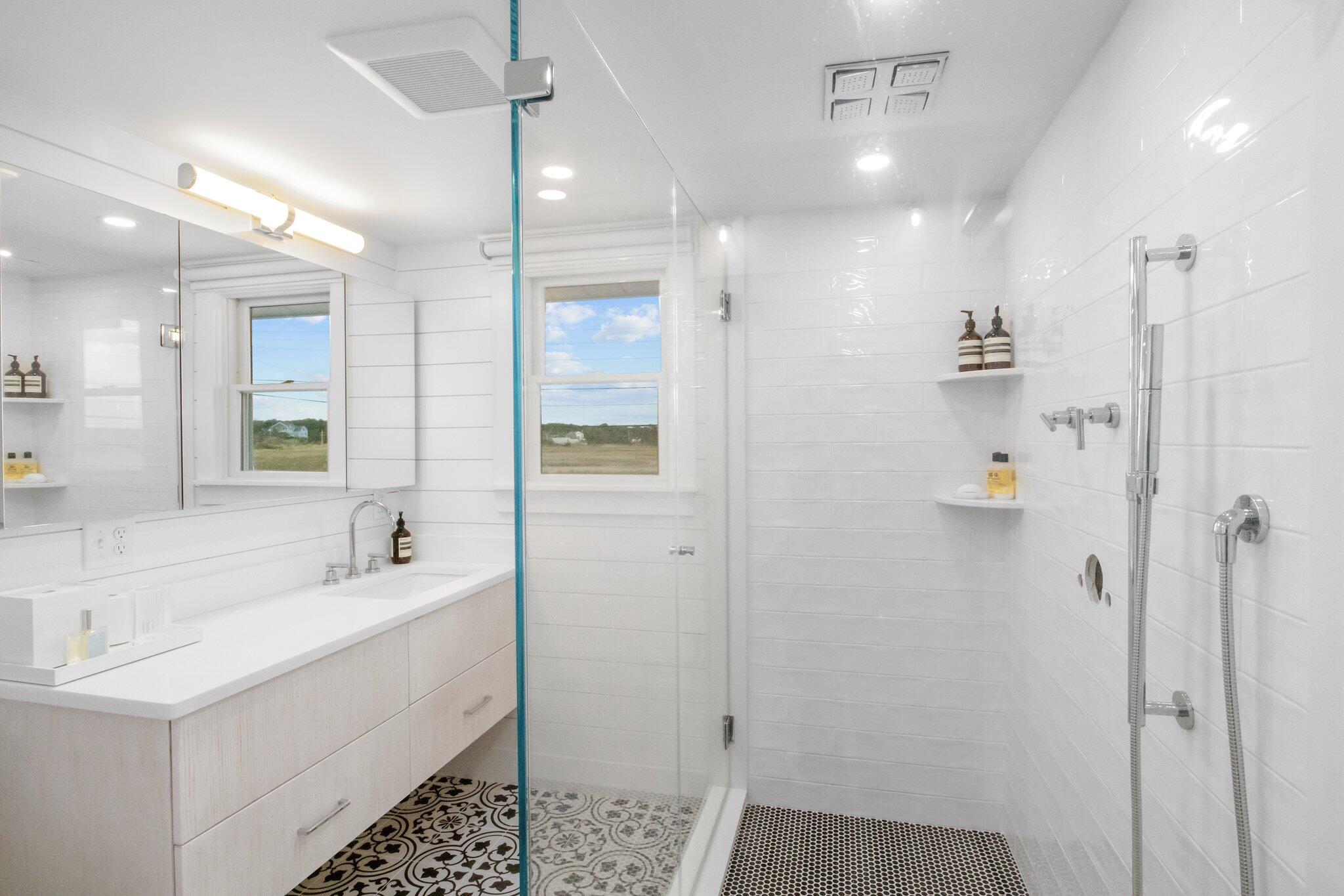 165 Harmes Way Eastham, MA 02642 - Photo 15 of 36 a bathroom with a sink a toilet a large mirror and shower