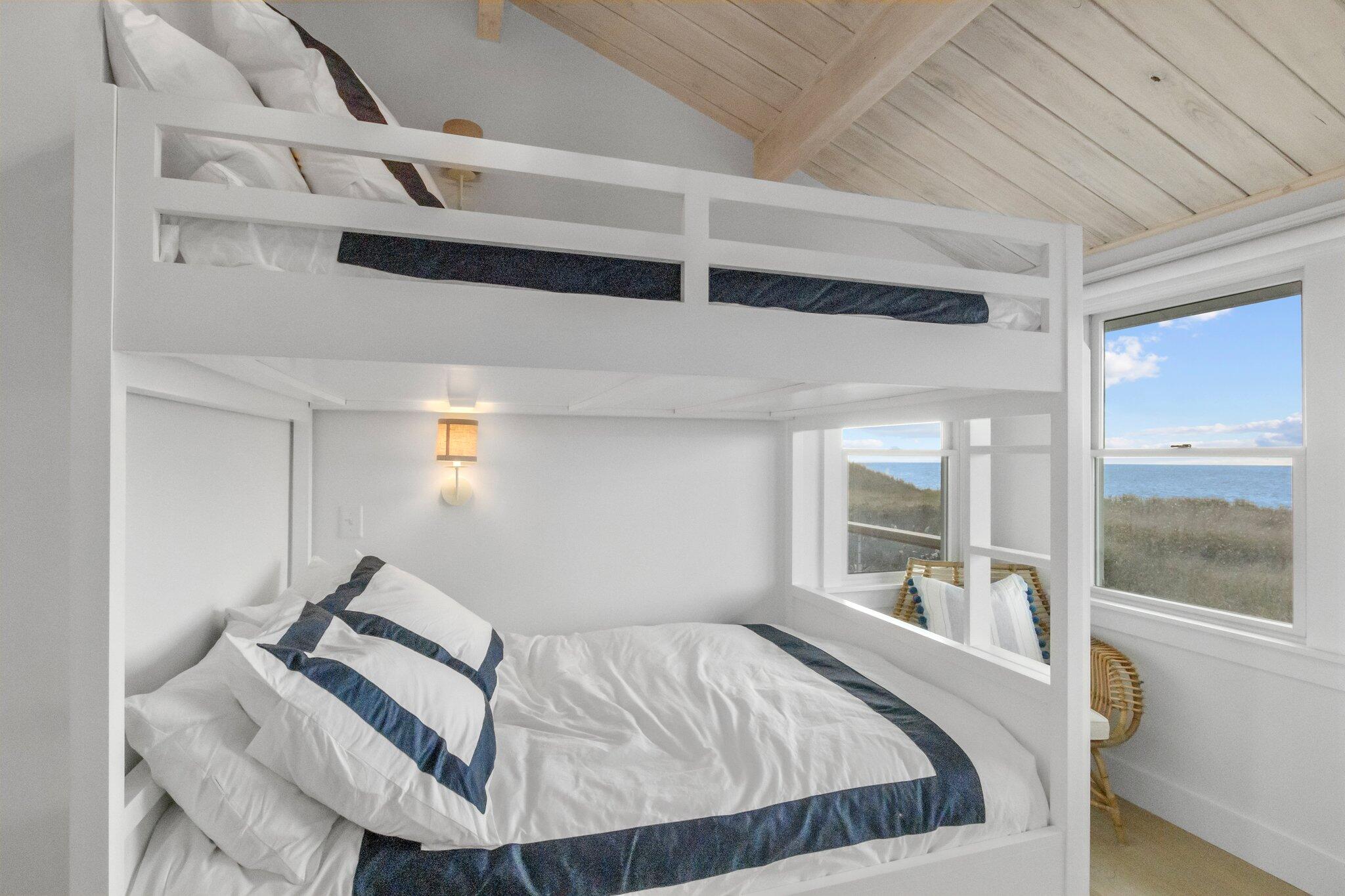 165 Harmes Way Eastham, MA 02642 - Photo 18 of 36 a bed sitting in a bedroom next to a window