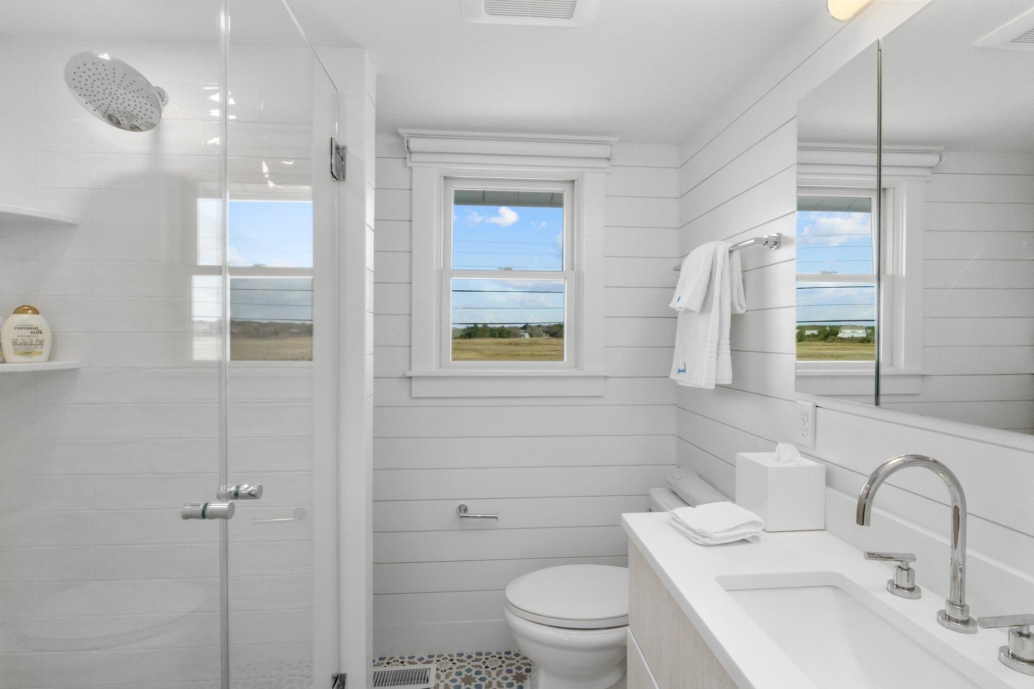 165 Harmes Way Eastham, MA 02642 - Photo 19 of 36 a bathroom with a toilet sink and mirror