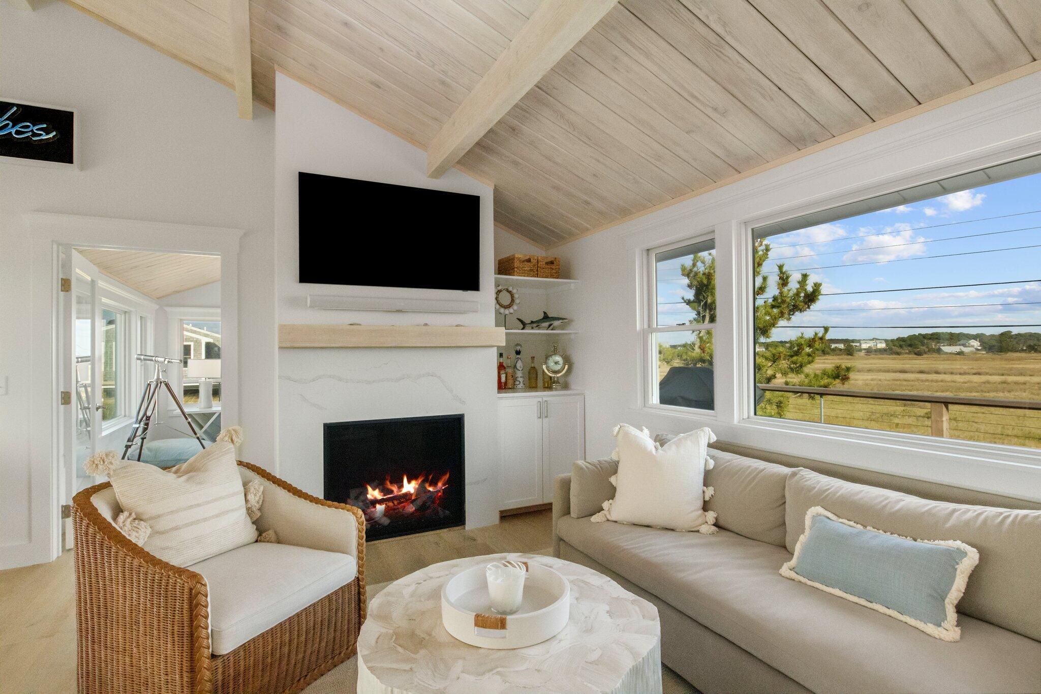 165 Harmes Way Eastham, MA 02642 - Photo 6 of 36 a living room with furniture a flat screen tv and a fireplace