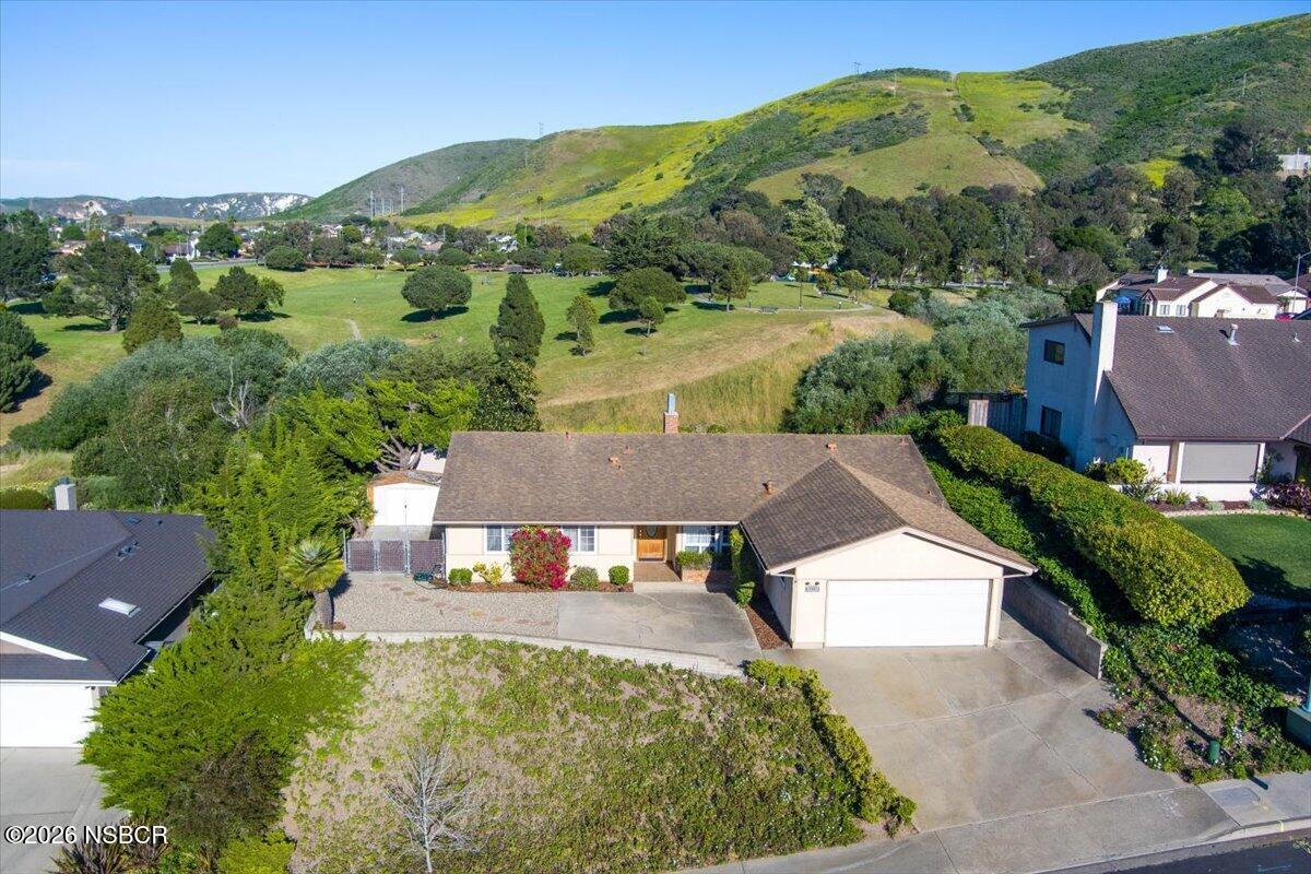 an aerial view of a house with a yard