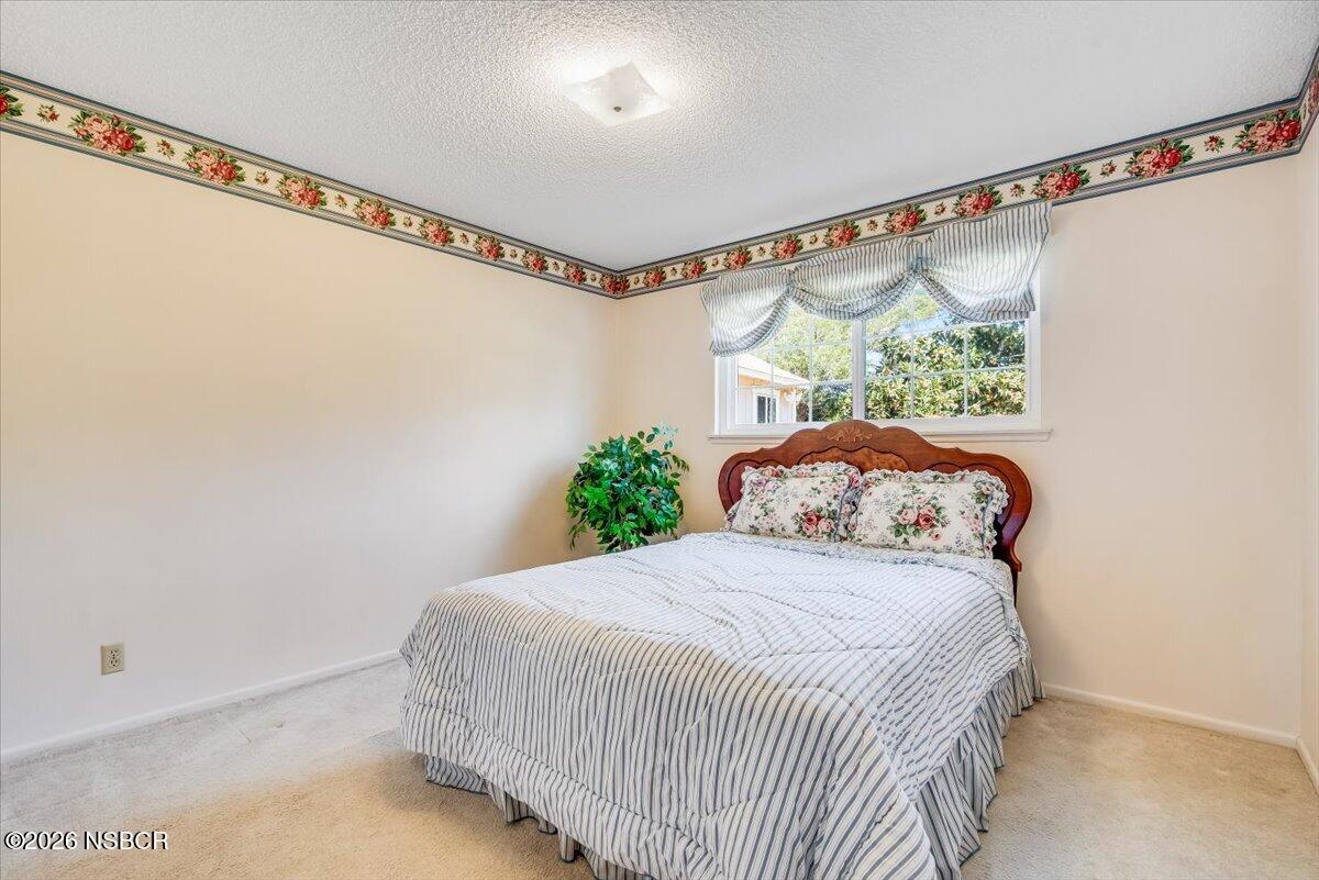 416 South Hawthorne Street Lompoc, CA 93436 - Photo 17 of 29 a bedroom with a bed window and a ceiling fan