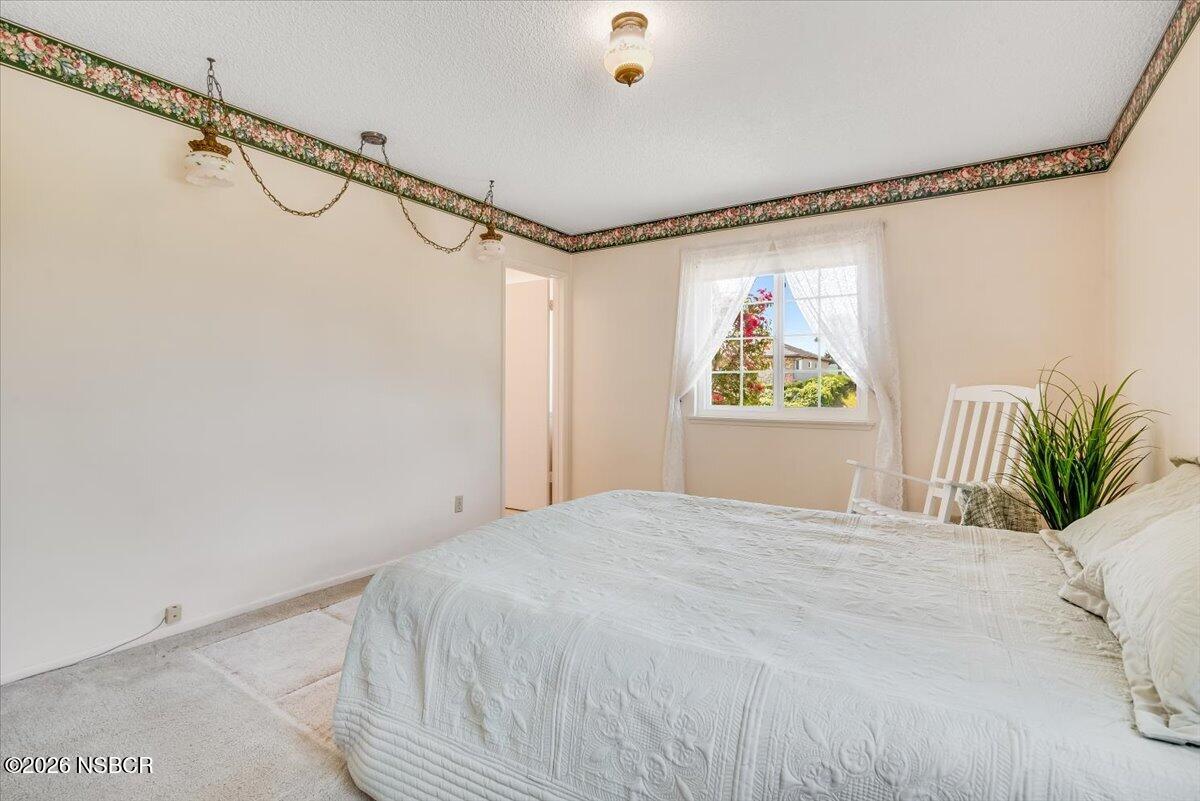 416 South Hawthorne Street Lompoc, CA 93436 - Photo 21 of 29 a bedroom with a bed and a painting on the wall