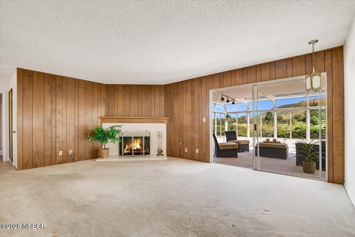 416 South Hawthorne Street Lompoc, CA 93436 - Photo 5 of 29 a view of a livingroom with furniture flat screen tv and floor to ceiling window