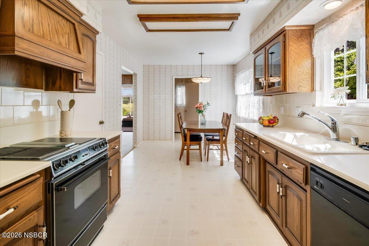 416 South Hawthorne Street Lompoc, CA 93436 - Photo 8 of 29 a kitchen with stainless steel appliances granite countertop a stove a sink and a microwave