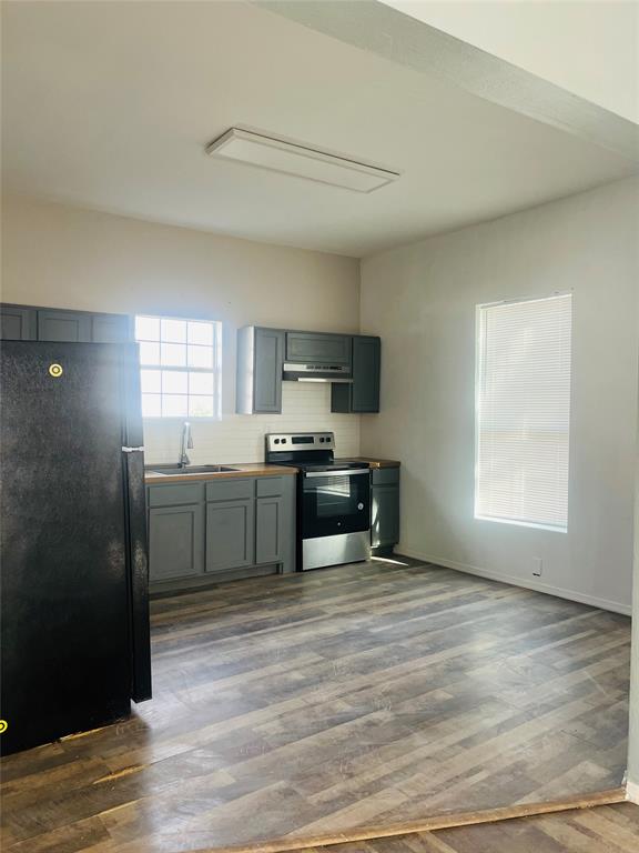 918 South Maxey Street Sherman, TX 75090 - Photo 5 of 13 a kitchen with a cabinets and appliances