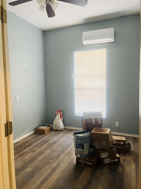 918 South Maxey Street Sherman, TX 75090 - Photo 8 of 13 a bedroom with a bed and wooden floor