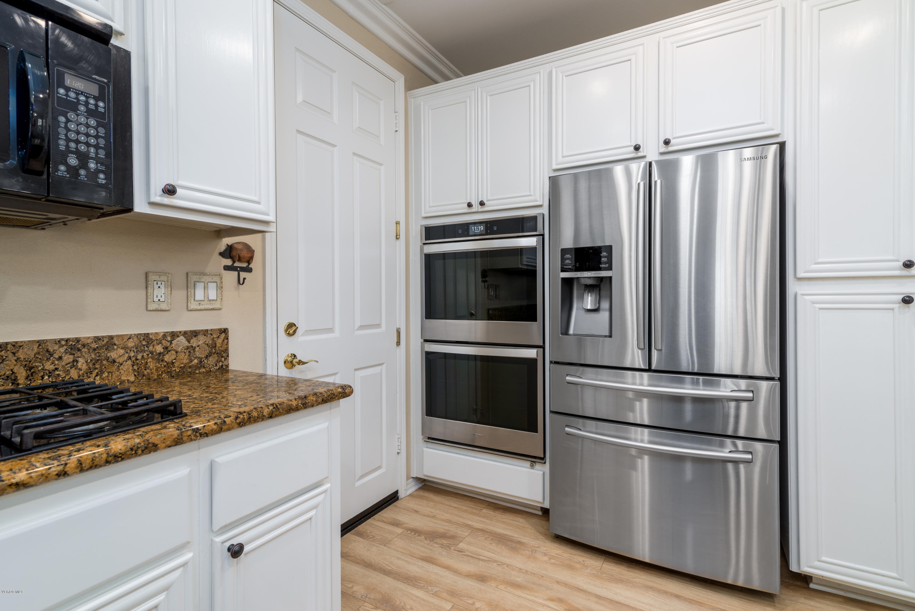 421 Spring Park Road Camarillo, CA 93012 - Photo 13 of 51 a kitchen with stainless steel appliances granite countertop a refrigerator stove and white cabinets