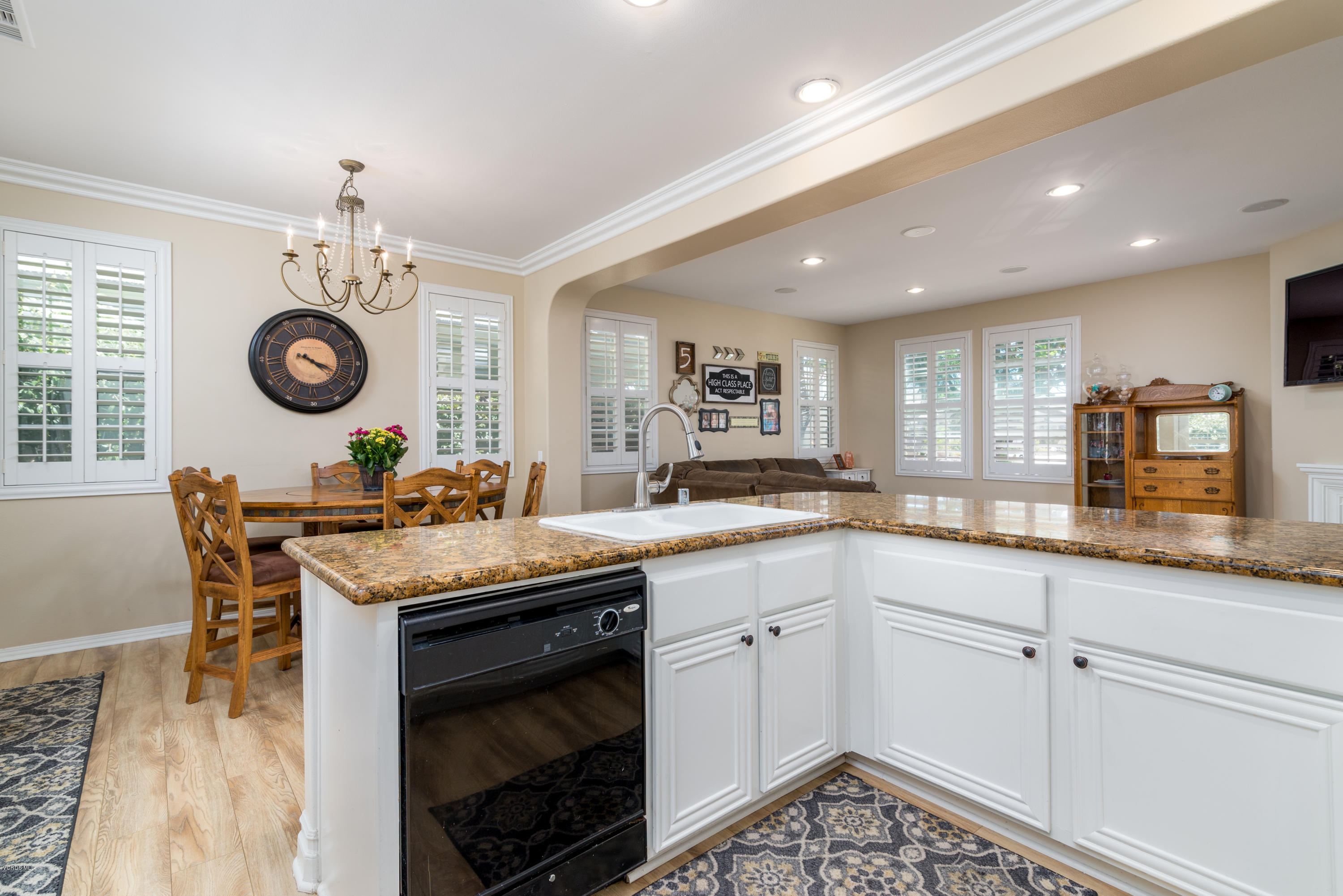 421 Spring Park Road Camarillo, CA 93012 - Photo 14 of 51 a kitchen with granite countertop a stove a sink a dining table and chairs