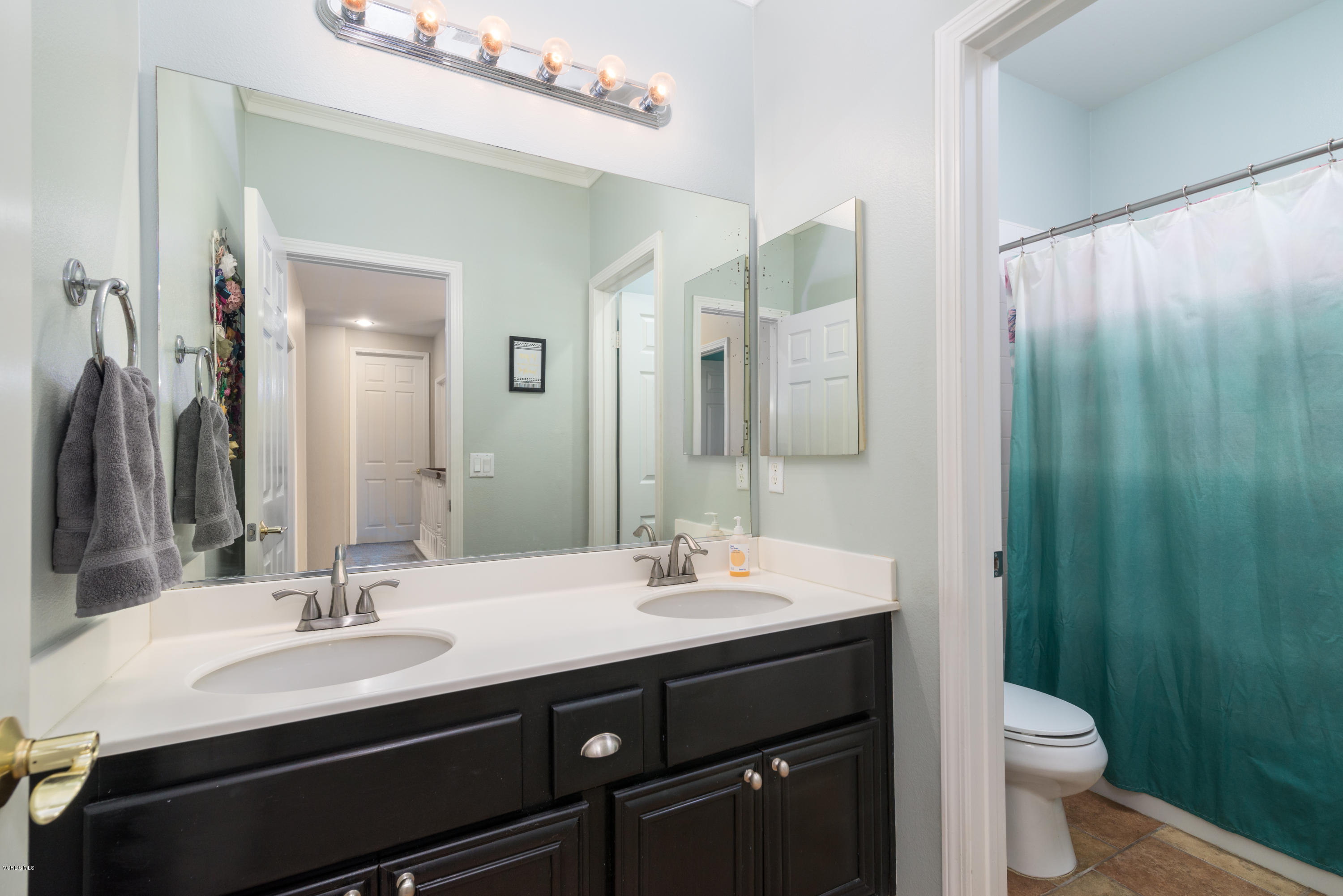 421 Spring Park Road Camarillo, CA 93012 - Photo 27 of 51 a bathroom with a double vanity sink toilet and a mirror