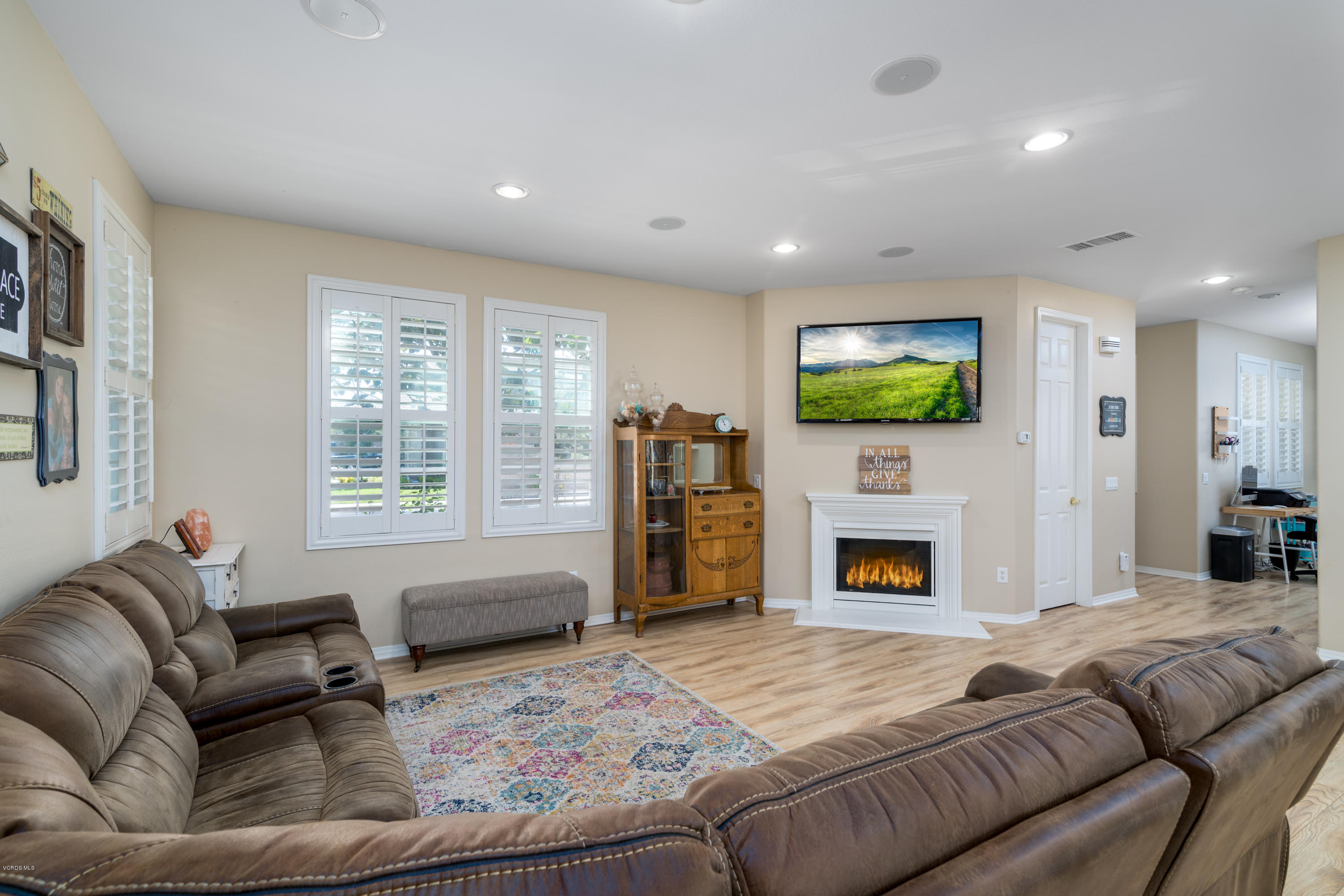 421 Spring Park Road Camarillo, CA 93012 - Photo 9 of 51 a living room with furniture a fireplace and a flat screen tv