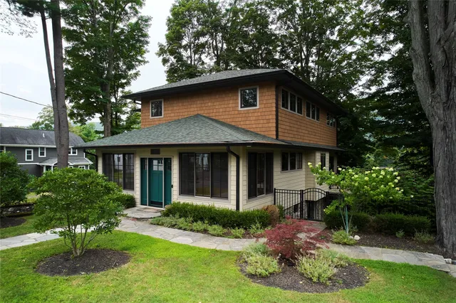 a front view of house with yard and green space