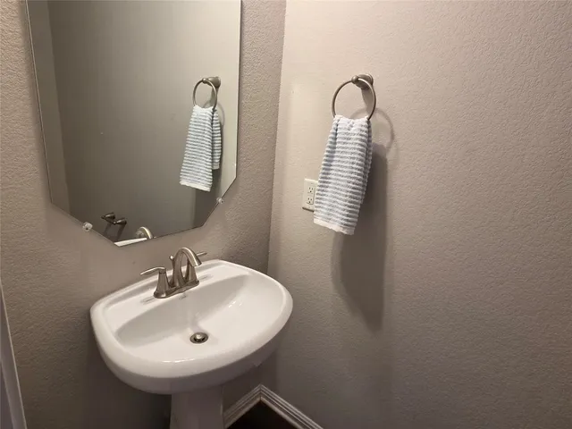 a bathroom with a sink and mirror
