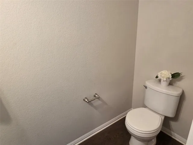 a white toilet sitting next to a small sink