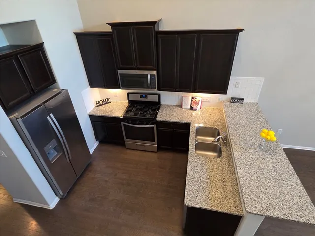 a kitchen with a refrigerator and a stove
