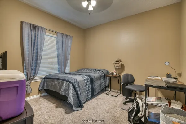 a bedroom with a bed and a chair