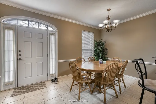 a view of a dining room with furniture and chandelier