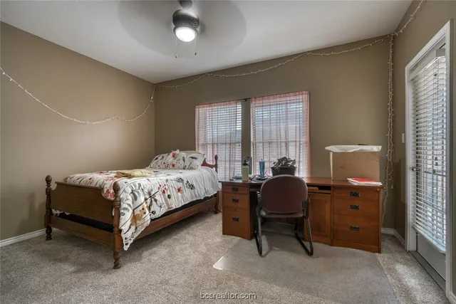 a bedroom with a bed chair and window