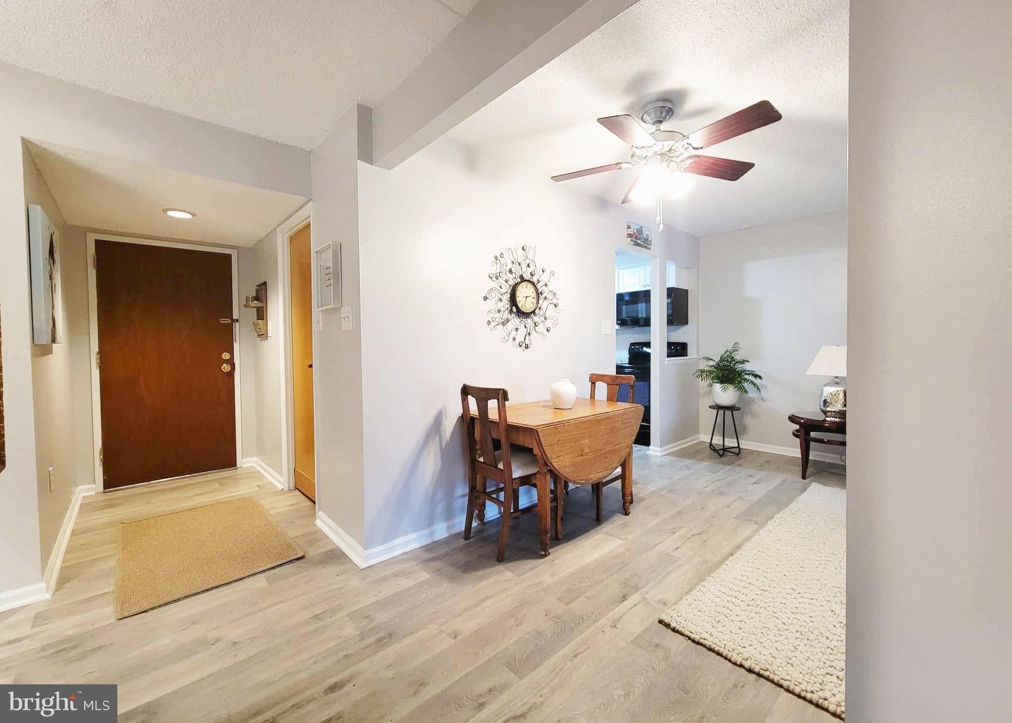 800 Avondale Road, Unit 7N Wallingford, PA 19086 - Photo 12 of 32 a living room with furniture and a chandelier