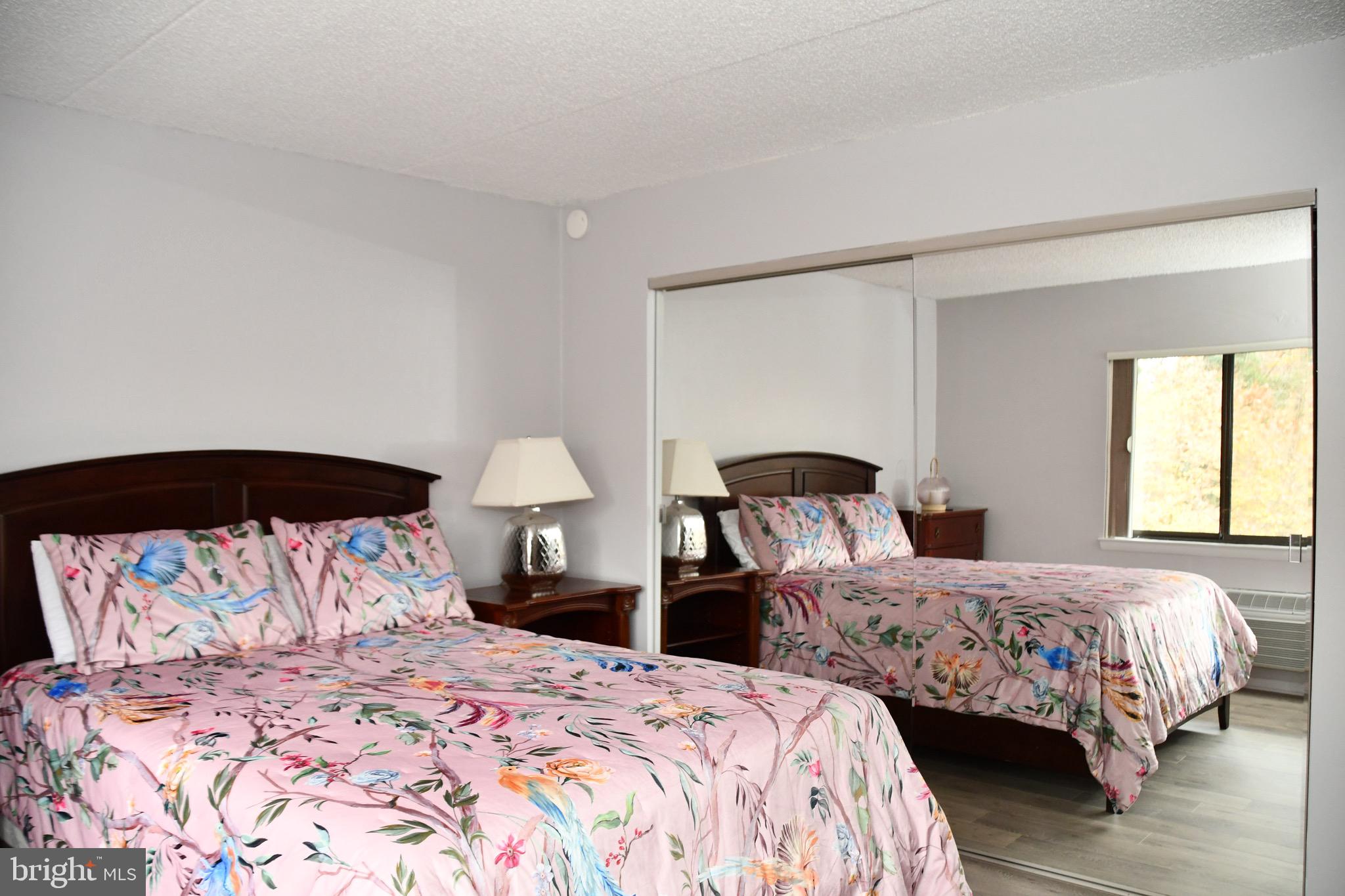800 Avondale Road, Unit 7N Wallingford, PA 19086 - Photo 25 of 32 a bedroom with two beds and a large mirror