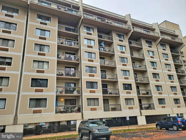a hallway with wooden floor and stairs