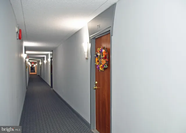 a view of a hallway with wooden shelves