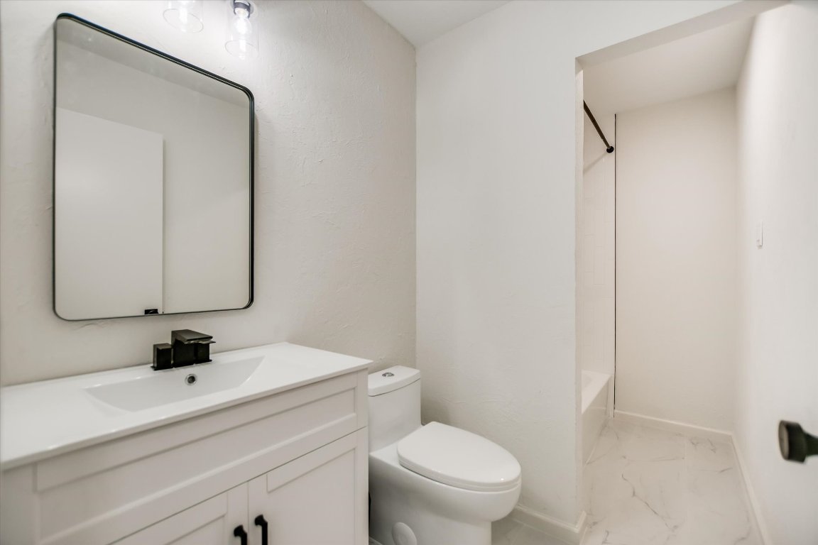 7003 Castlekeep Way Austin, TX 78745 - Photo 18 of 23 a bathroom with a sink a toilet and mirror